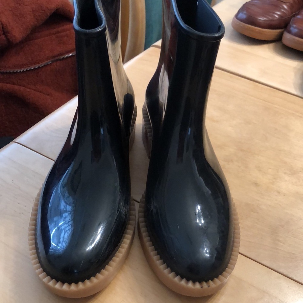 Melissa rain boots.  Glossy black with tan sole.  Size 9